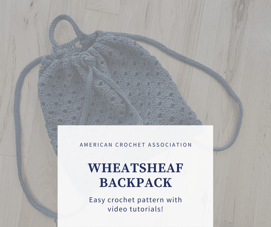Wheatsheaf crochet backpack laying flat on wooden floor