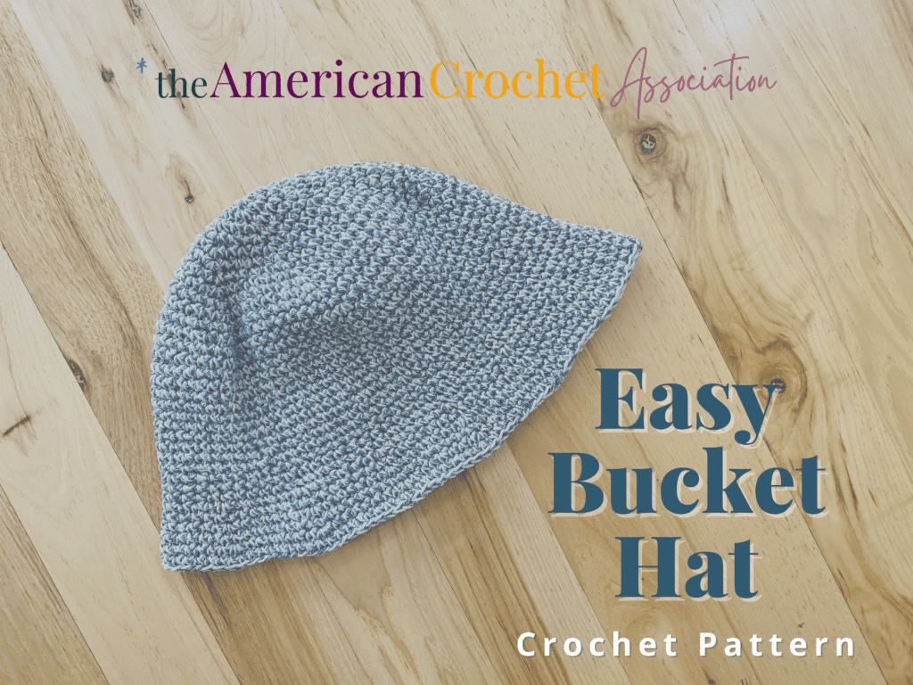 Blue crochet bucket hat flat on wooden floor