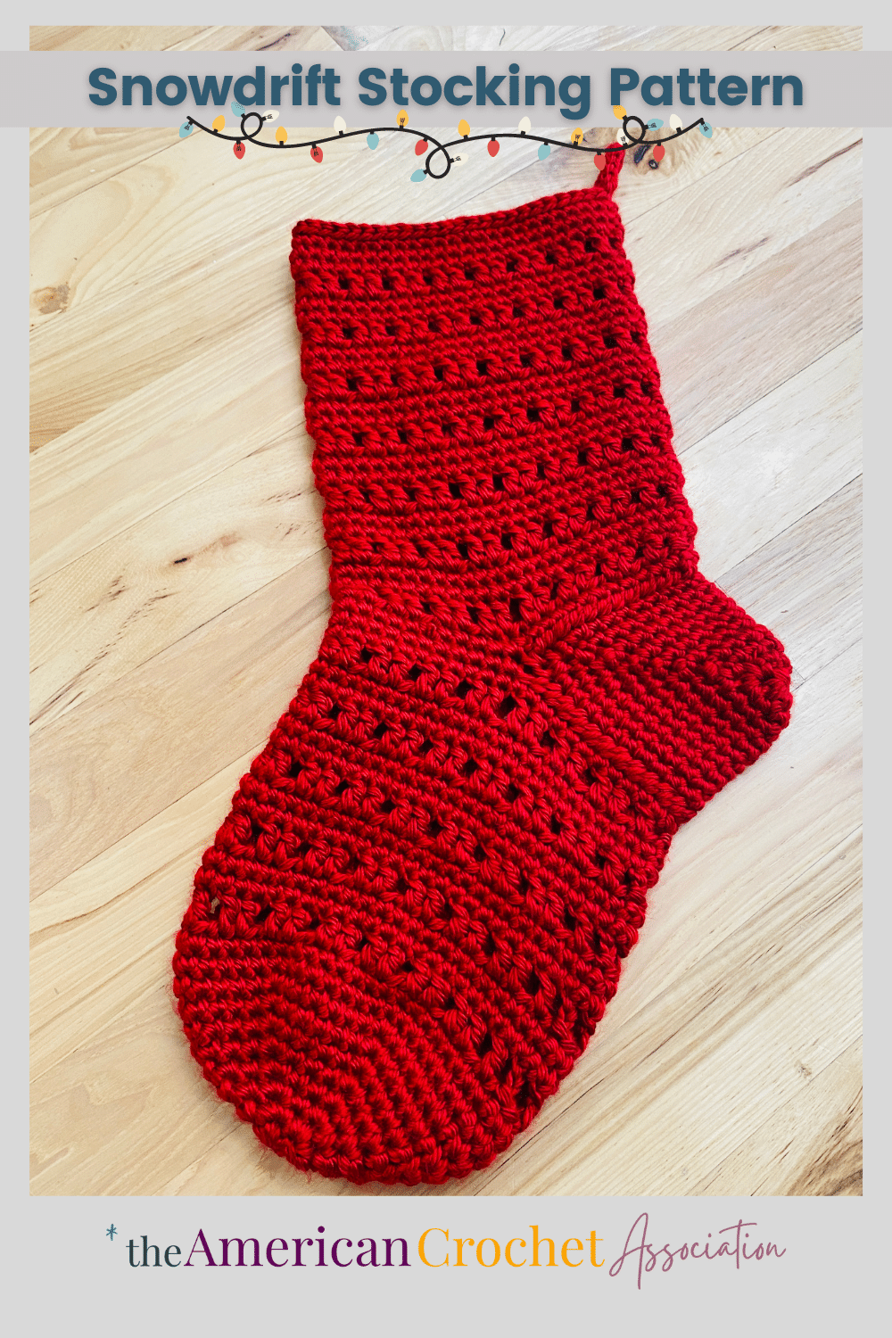 Red crochet stocking on wooden floor