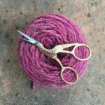 Yarn cake with gold crane scissors - American Crochet Association