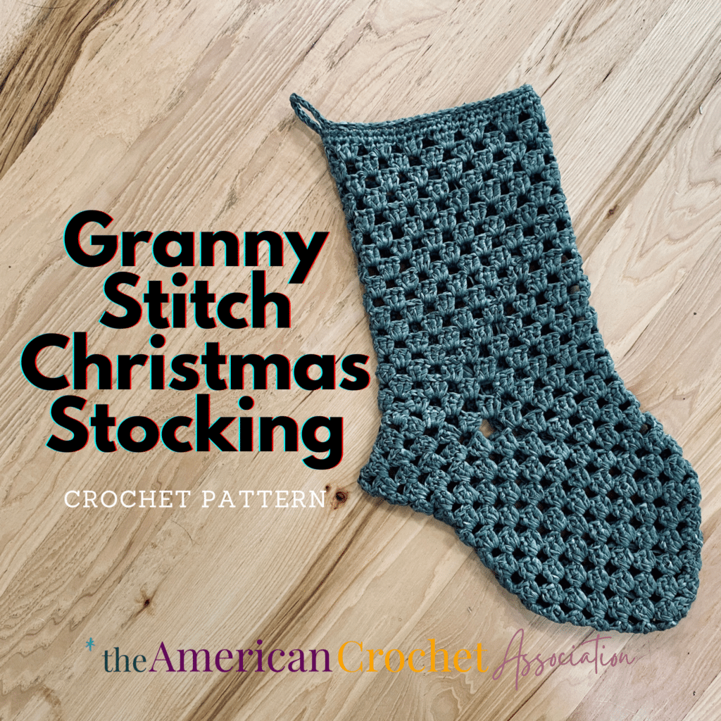 Granny Stitch Christmas Stocking Crochet Pattern on wooden floor Close up - American Crochet Association