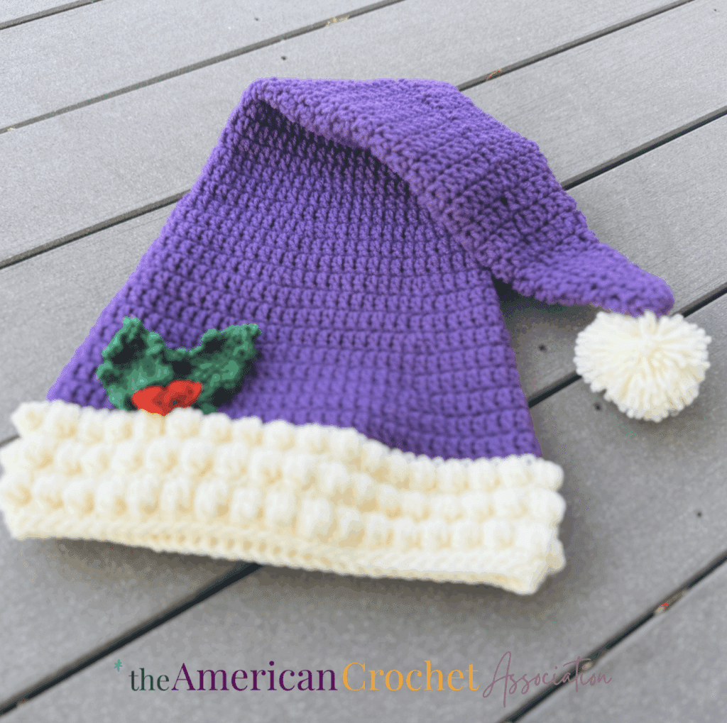 Long Santa Hat folded over and on ground - Salena Baca Crochet - American Crochet Association